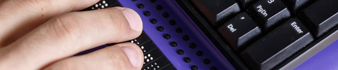 Blind person using computer with braille computer display