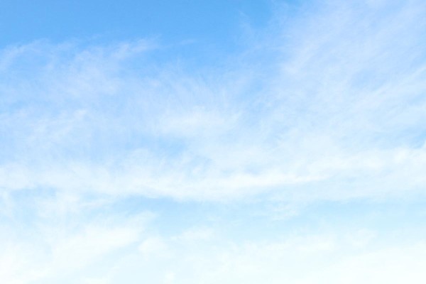 Blue sky with some wisps of cloud