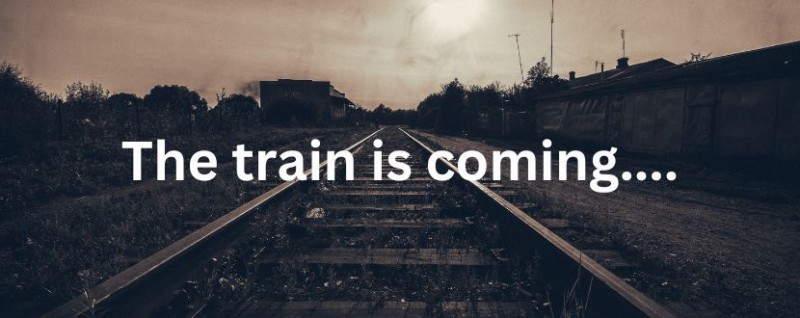 A sepia photo of a set of railway tracks. The words “A train is coming” is displayed over the front of it.