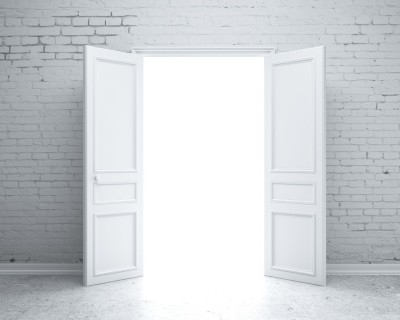 A wide doorway with open double doors, revealing white light beyond