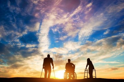 Three disabled people looking at the sunset