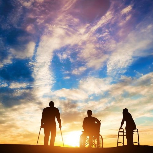 Three disabled people looking at the sunset